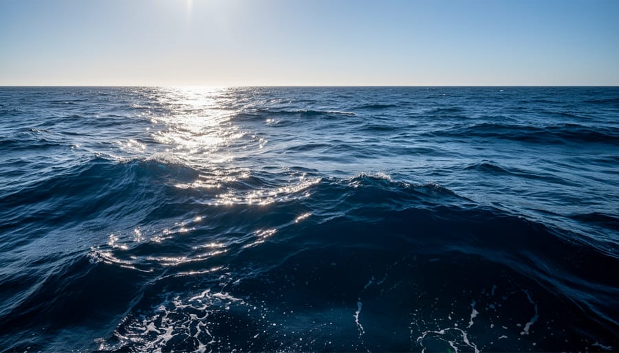 Dark ocean water near the shoreline with subtle wave texture under overcast light